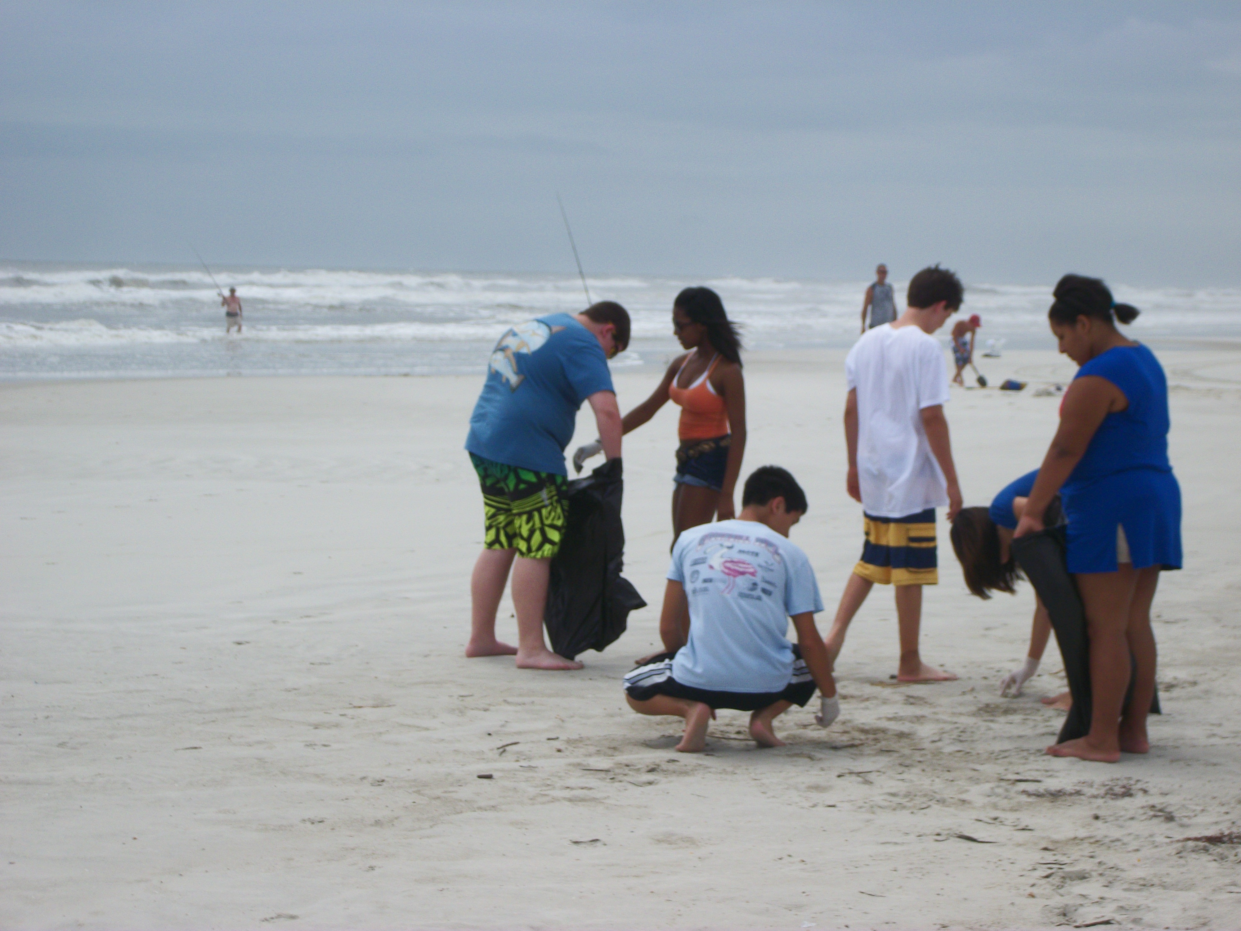 Student volunteering abroad on the beach.